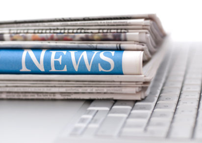 Stack of Newspapers on a computer keyboard